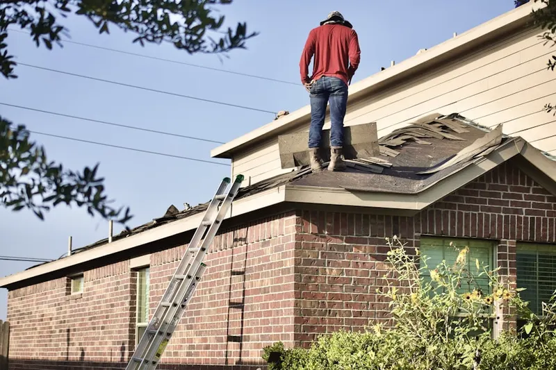 Professional roofer working on a residential roof in Twenty Row